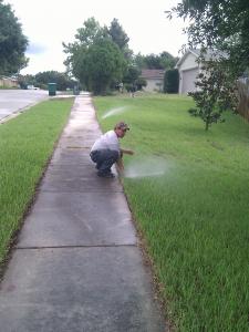 Roseville sprinkler repair technician readjusts head